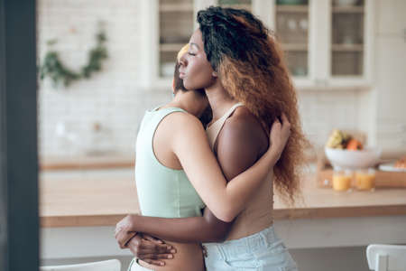 Profile African american woman hugging with girlfriendの写真素材