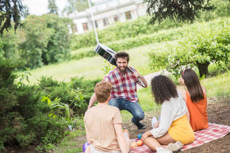 Guy with guitar rejoicing at meeting friends