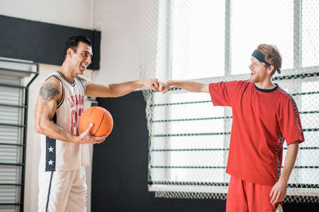 Two basketball players looking contented after the game