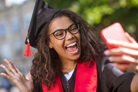 A girl having a video call and sharing good news about graduation