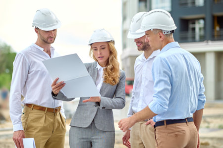 Concentrated woman inspector carrying out the building site inspection