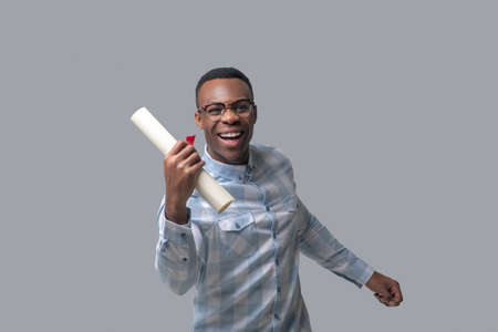 A dark-skinned man in a plaid shirt looking happyの写真素材