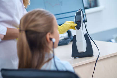 Blonde Caucasian girl undergoing a hearing screening procedureの写真素材