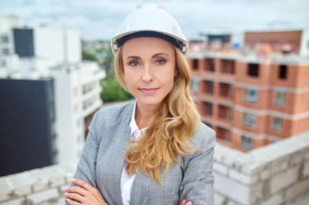 Calm construction manager in a safety helmet looking aheadの写真素材