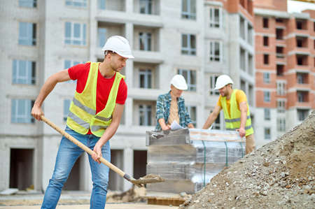 Hardworking Caucasian male builder working on the construction site