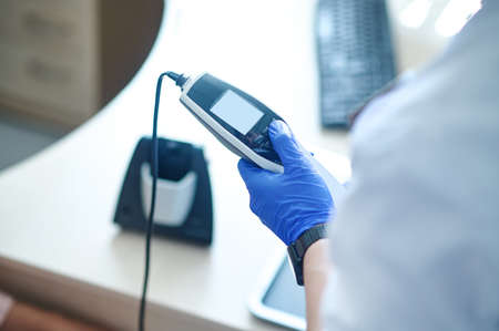 Otolaryngologist preparing the equipment for an audiometry testの写真素材