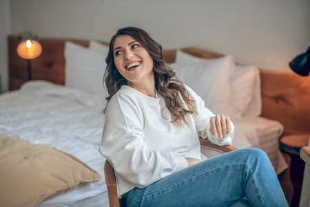 Pretty young long-haired woman in a white blouseの写真素材