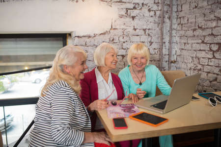 Three fashion designers discussing a new projectの写真素材