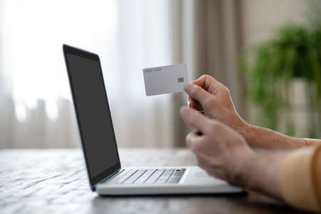 A man paying in internet using his credit cardの写真素材