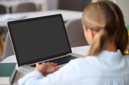 Young girl studying at a public libraryの写真素材