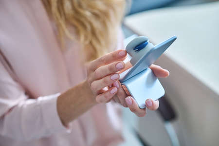 Modern model of human ear in hands of woman