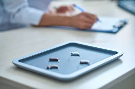 Hearing aid tray on otolaryngologists deskの写真素材