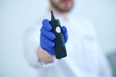 Doctor showing special device for examining earの写真素材