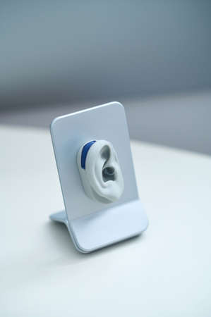 Small miniature of human ear on stand