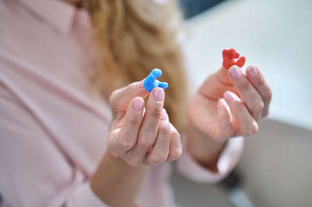 Modern hearing aid in hands of womanの写真素材