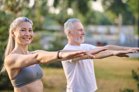 A mature couple exercising in the parkの写真素材
