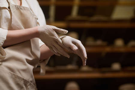 Close up of female potters hands in clayの写真素材