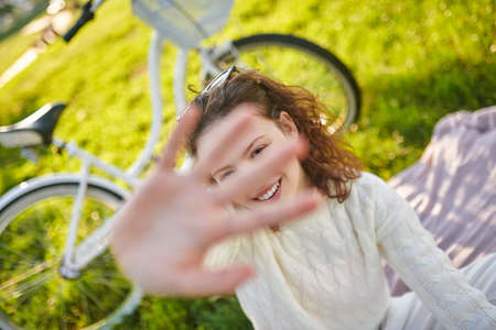 A girl raising her hand and protecting from photosの写真素材