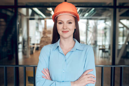 Optimistic young woman in safety helmetの写真素材