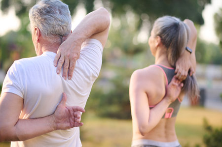 A man and a woman exercising in the parkの写真素材
