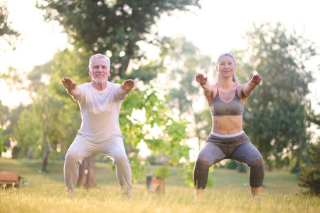 A man and a woman exercising in the parkの写真素材