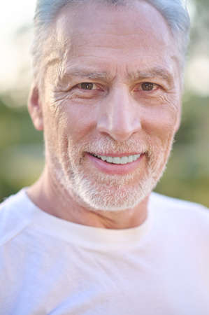 A picture of a gray-haired man looking confident
