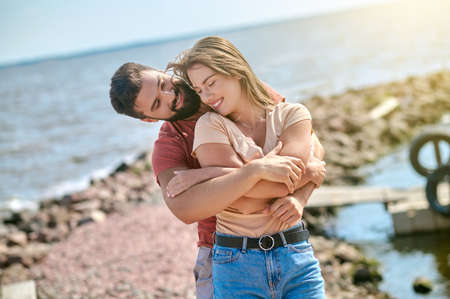 A happy couple feeling amazing spending time on a beachの写真素材