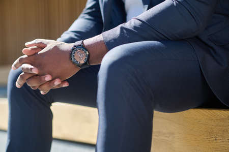 Close up picture of a man in a suit sitting on the benchの写真素材