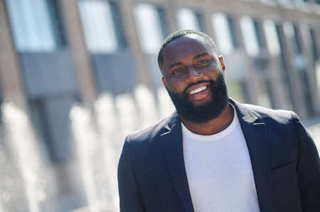 African american young man smiling and looking contentedの写真素材