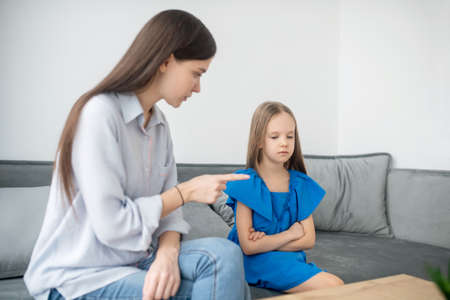 Mother and daughter ahving a conflict and looking stressedの写真素材