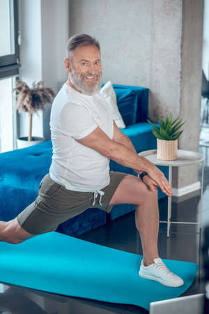 A mature man having a workout and doing long stepsの写真素材