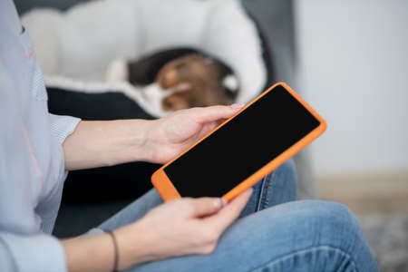 Close up picture of female hands with a tabletの写真素材