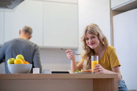 Dad making breakfast for his daughterの写真素材