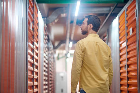 Profile of serious man looking at container doorの写真素材