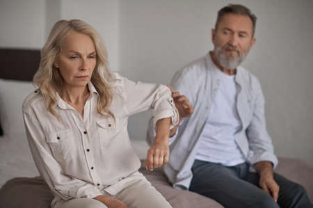 Displeased lady paying no attention to her husband