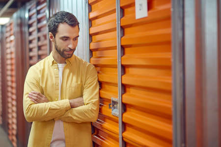 Interested man looking at garage lockの写真素材