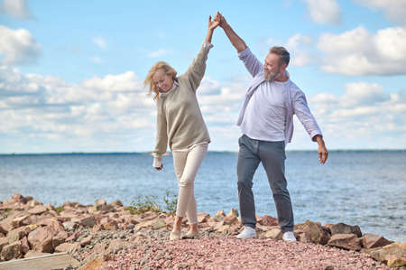 Man and woman having casual time near sea