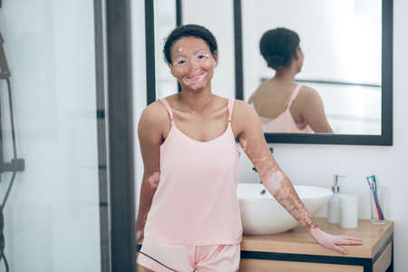 A pretty mulatta in lingerie in a bathroom in the mornignの写真素材