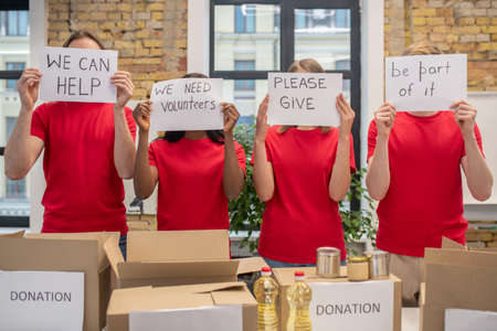 Young voluntteers at work in a distribution center looking busyの写真素材