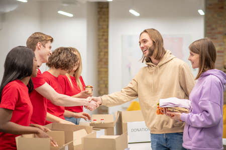 Volunteers working in a donations distribution centerの写真素材