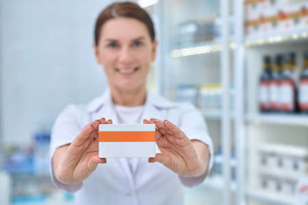 Pharmacist woman hands showing medicine boxの写真素材