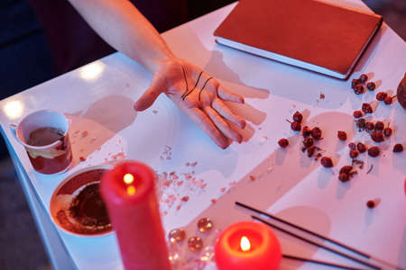 Chiromantist demonstrating three main lines on the palmの写真素材