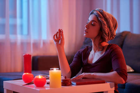 Serene fortune-teller holding a clear round crystal