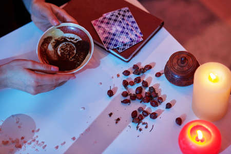 Experienced coffee reader predicting her future during the tasseographyの写真素材