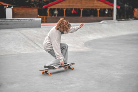 Girl on bent legs balancing on skateboardの写真素材