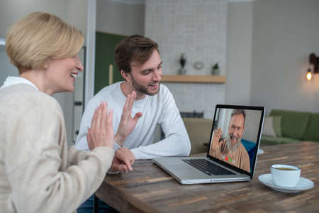 Two people at home with a laptop
