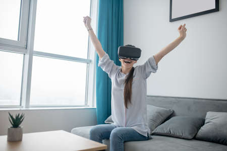 Female gamer enjoying a 3D simulation gameの写真素材