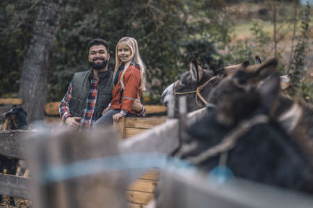 Farmer and his daughter spending time on a farmの写真素材