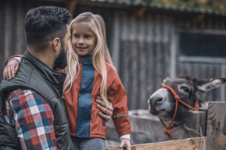 Farmer and his daughter spending time on a farmの写真素材