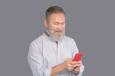 Mature man with a smartphone in hands